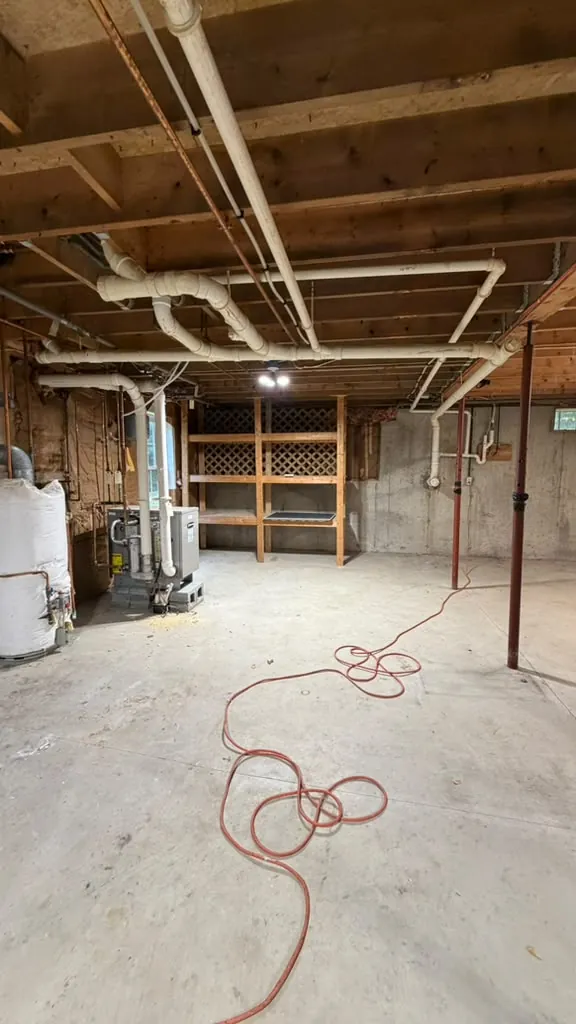 Basement with exposed joists, clean and ready for work